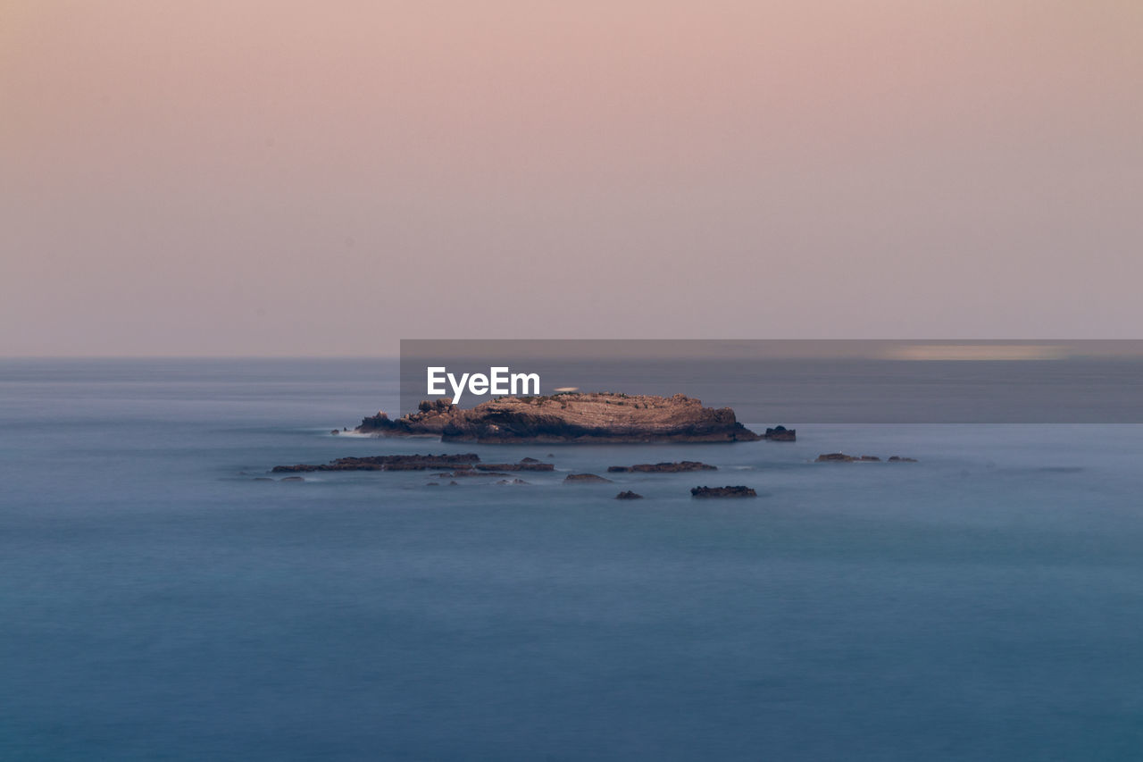 Scenic view of sea against clear sky during sunset