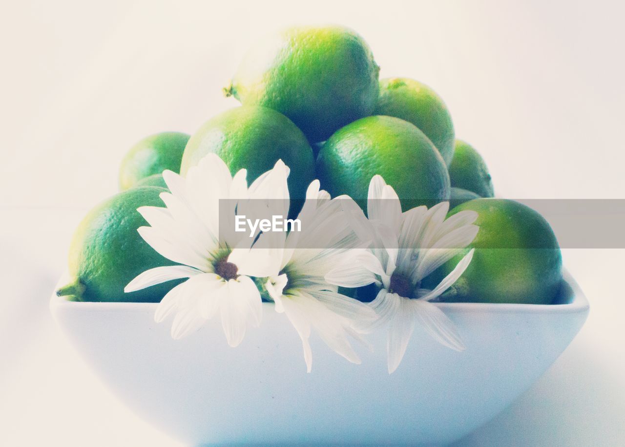 Close-up of green limes in bowl