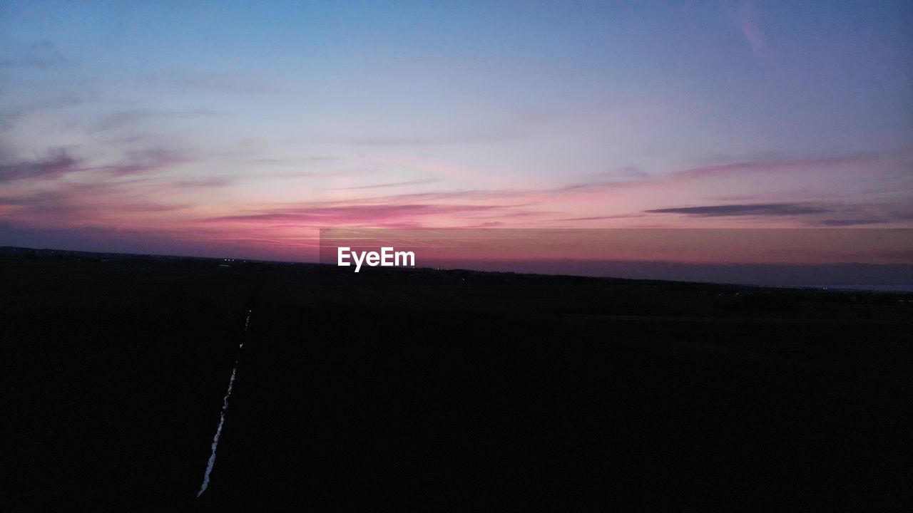 SCENIC VIEW OF SILHOUETTE LAND AGAINST ROMANTIC SKY AT SUNSET