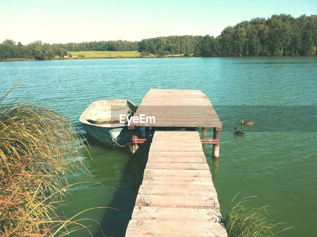 High angle view of boat moored by pier over river