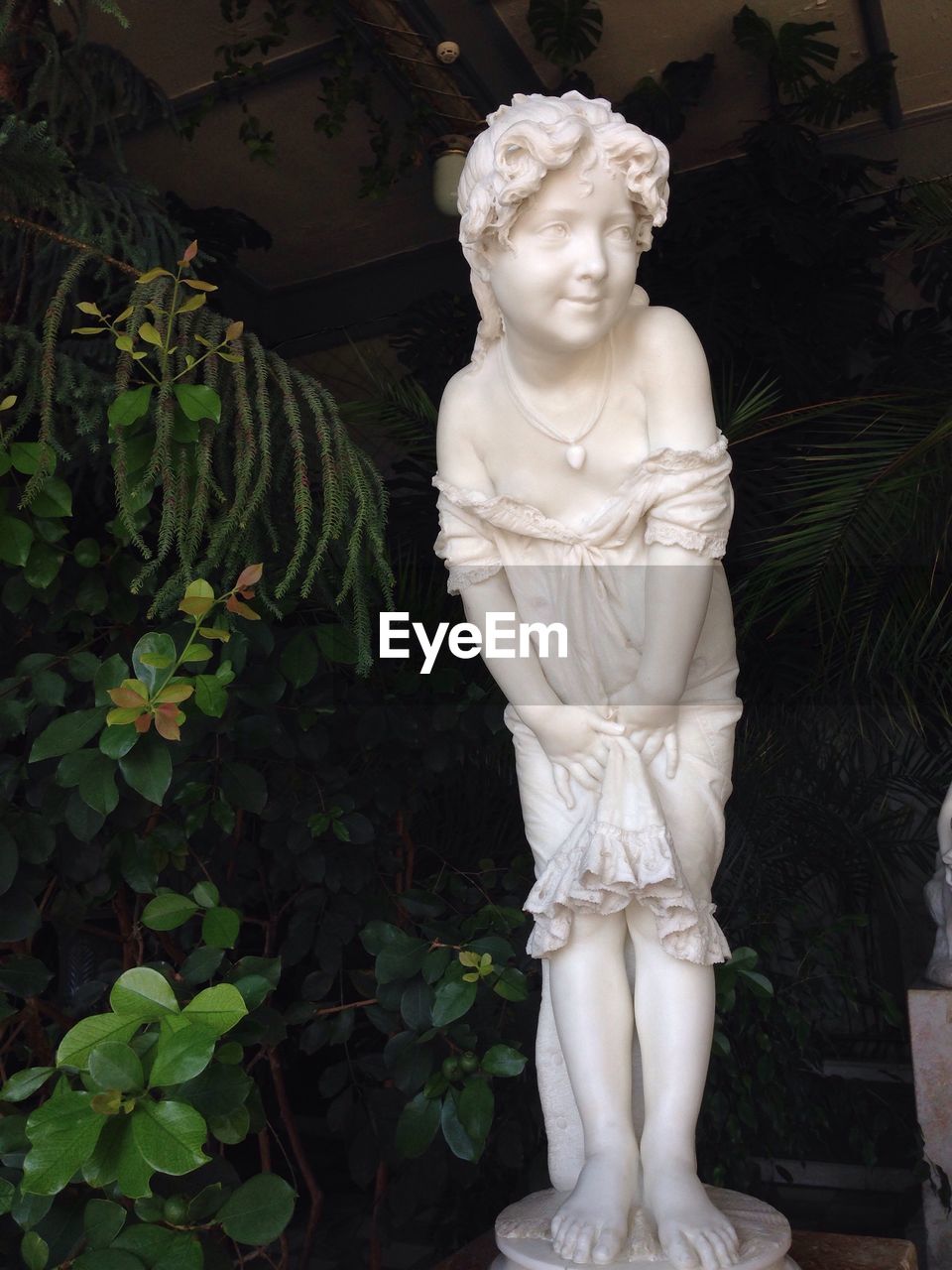 STATUE AGAINST WHITE SCULPTURE OF LARGE BUDDHA