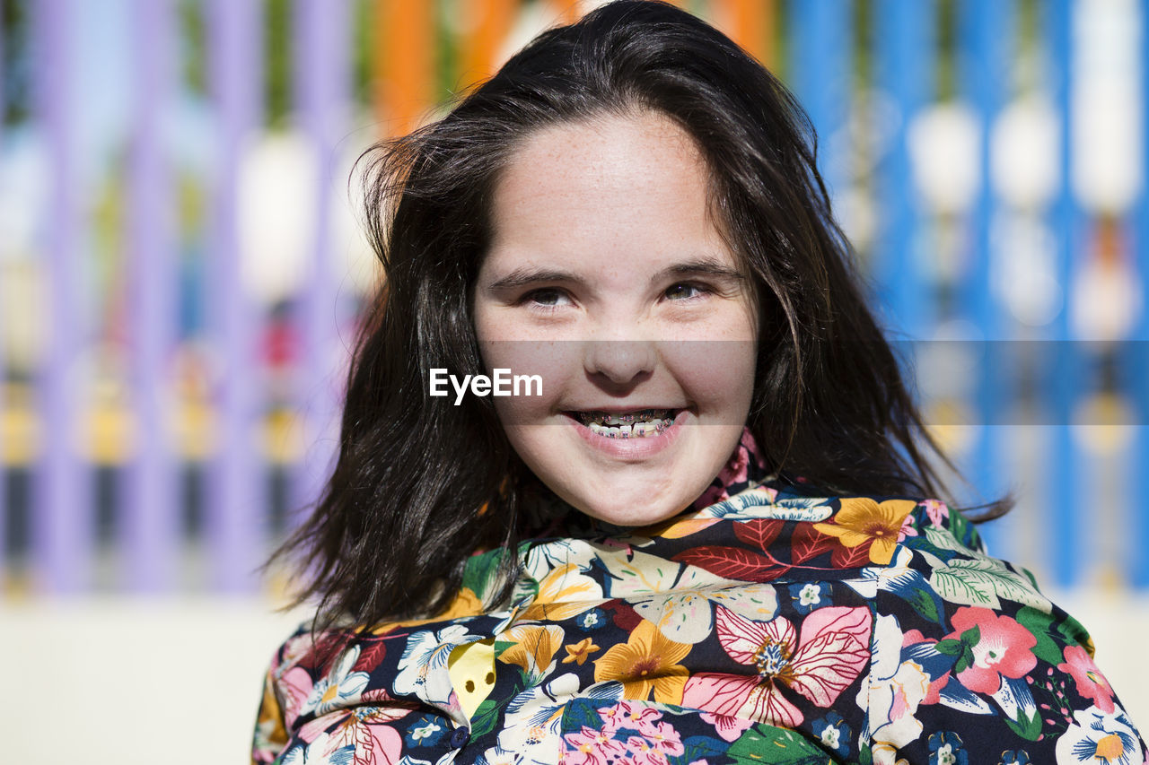 Teenager girl with down syndrome smiling, braces