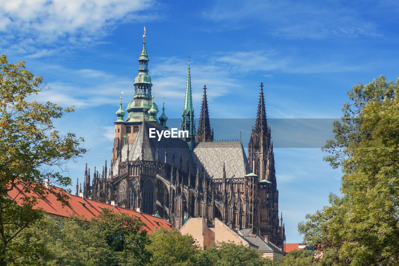 Prague castle complex skyline. the rooftops of saint vitus cathedral early after sunrise. 