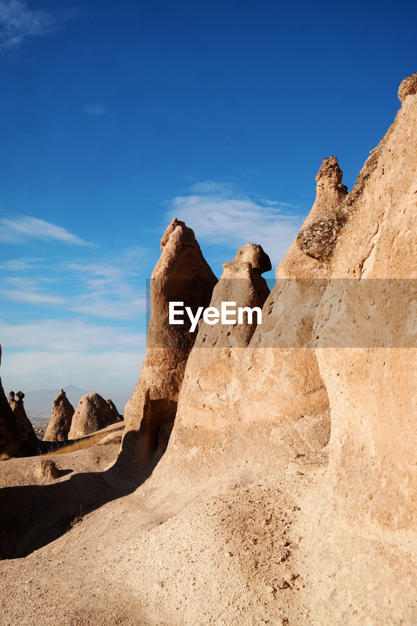 ROCK FORMATION IN DESERT AGAINST SKY