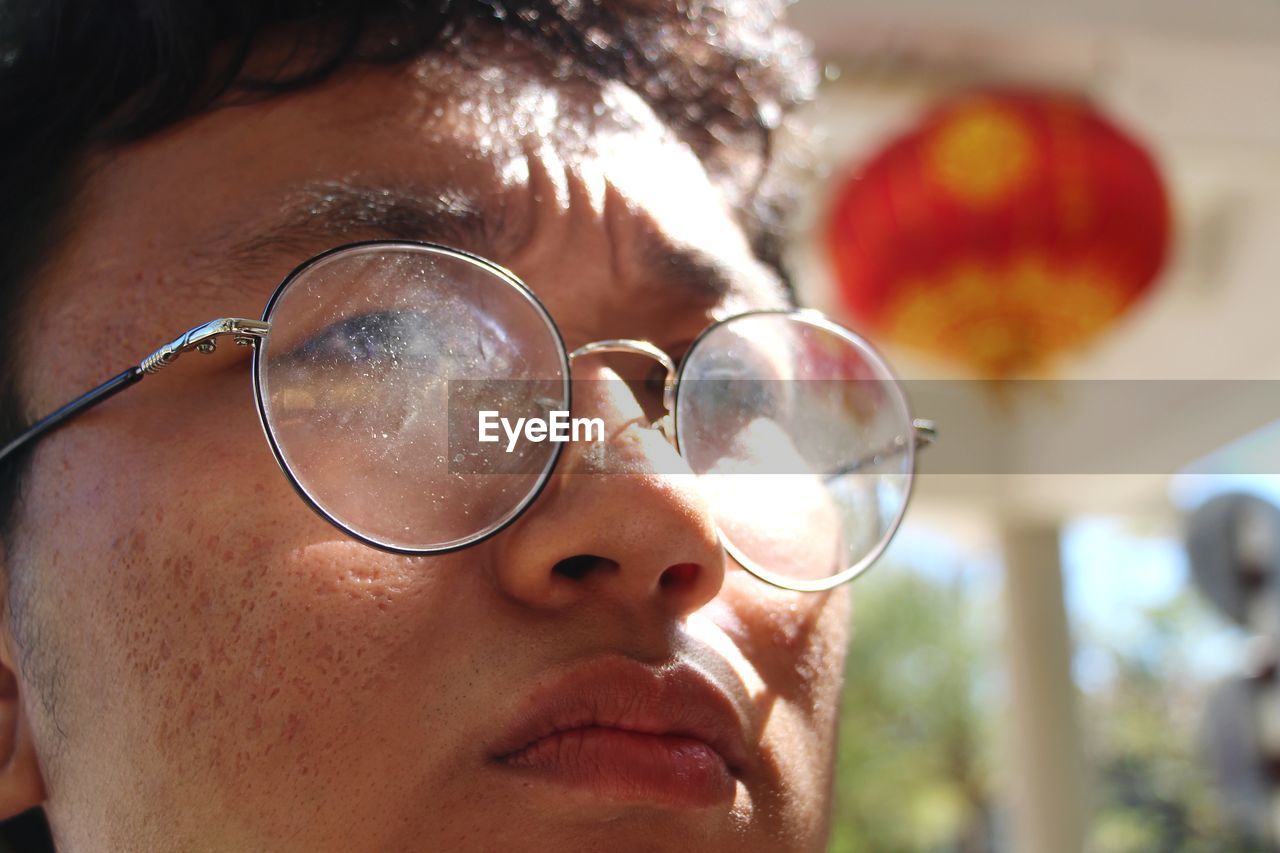 Close-up of man with eyeglasses looking away