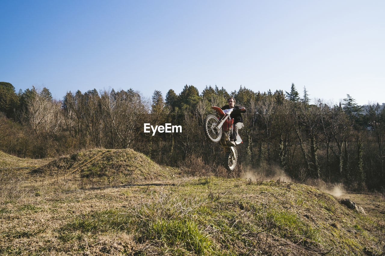 Senior motocross driver riding on circuit