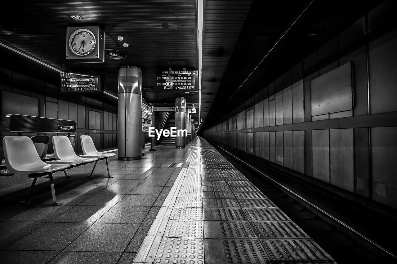 Illuminated railroad station platform at night