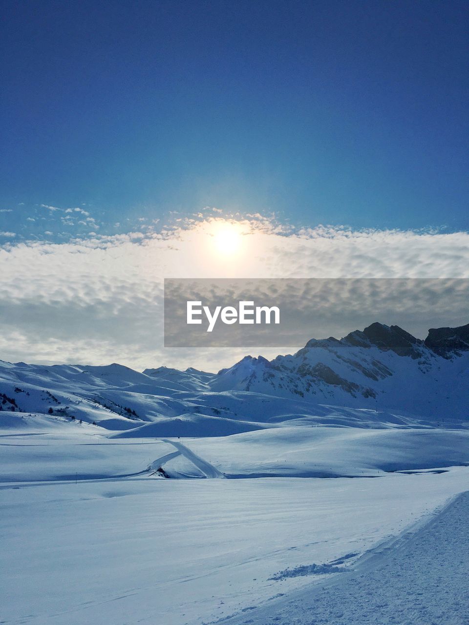 Scenic view of snow covered mountains against sky