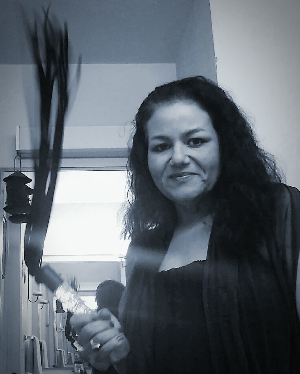 Portrait of woman holding whip at home