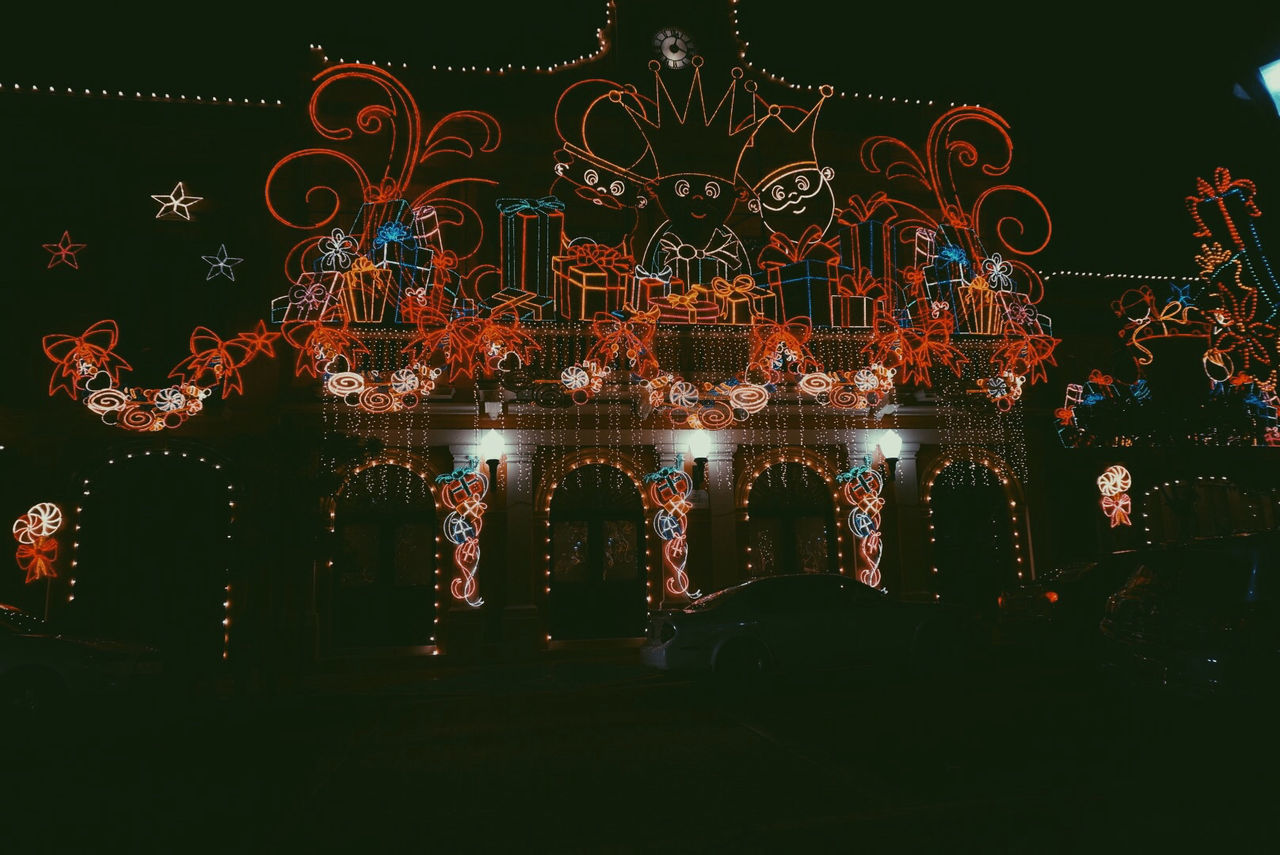 LOW ANGLE VIEW OF ILLUMINATED COLORFUL LIGHT AT NIGHT