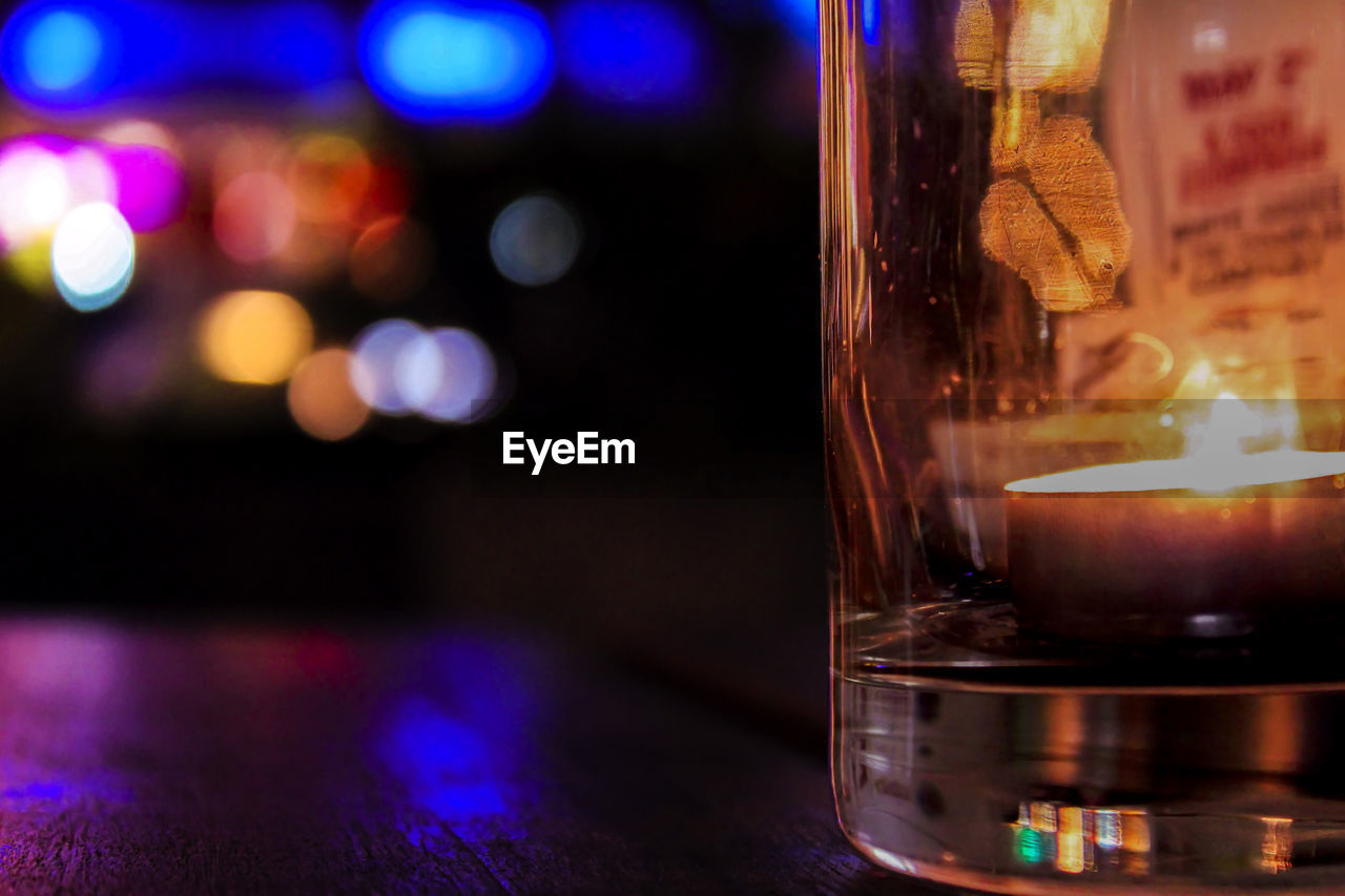 illuminated, light, candle, lighting, no people, night, glass, focus on foreground, close-up, indoors, burning, flame, fire, food and drink, table, lighting equipment, drink, alcohol, drinking glass, alcoholic beverage, bar, refreshment, household equipment, reflection, still life