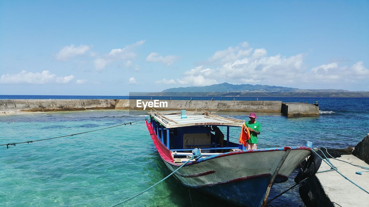 Two men on anchored fishing boat