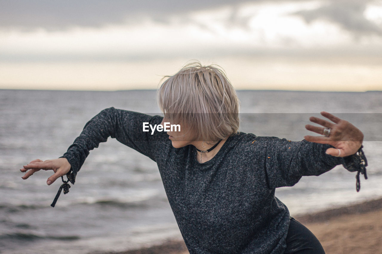 Young woman dancing at beach