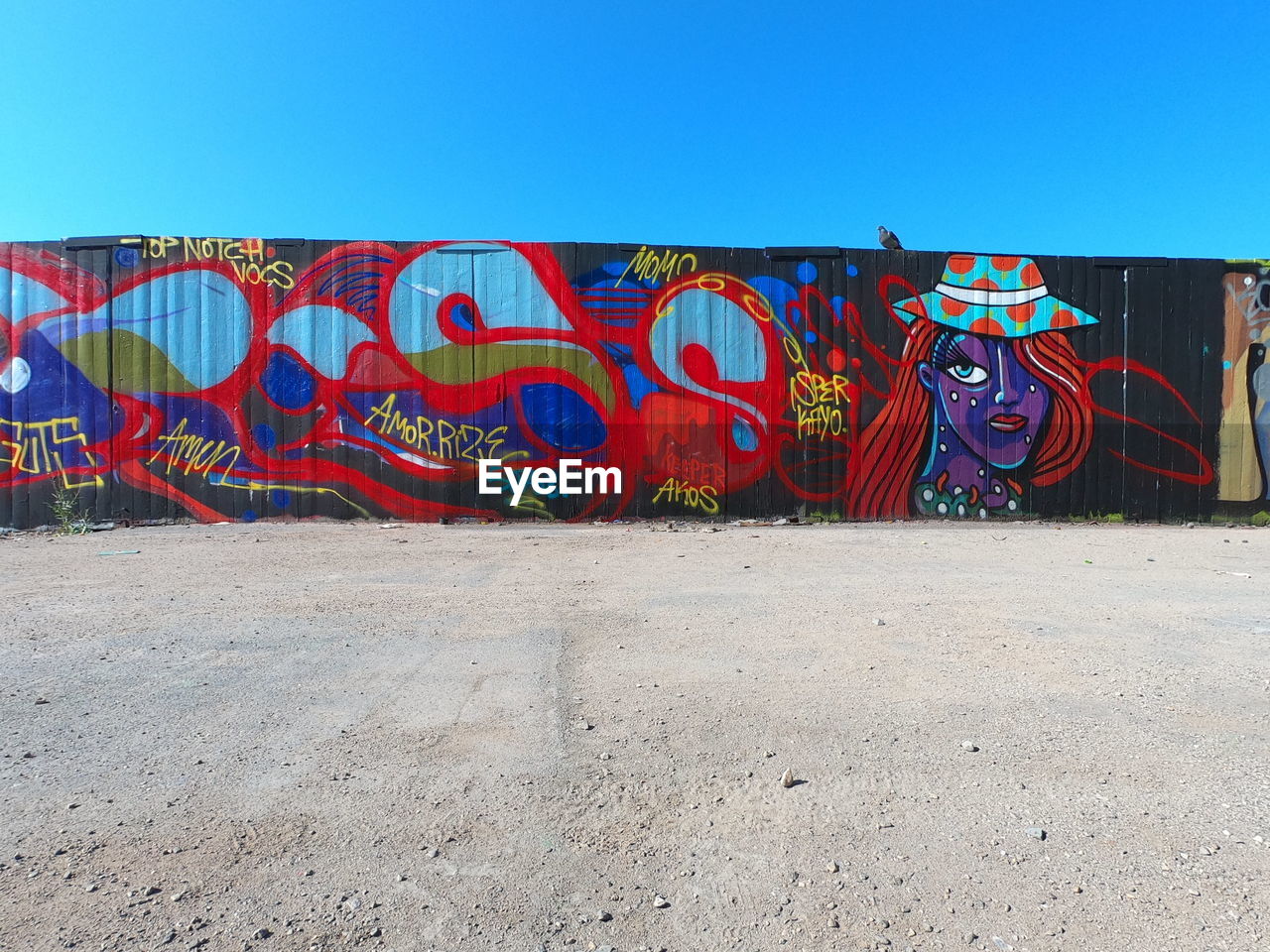 GRAFFITI ON WALL AGAINST CLEAR SKY