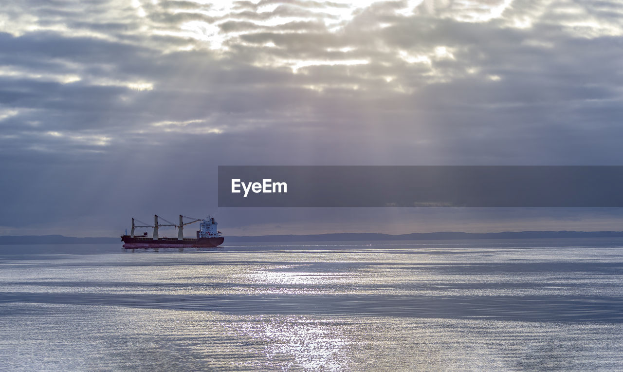 NAUTICAL VESSEL SAILING ON SEA AGAINST SKY