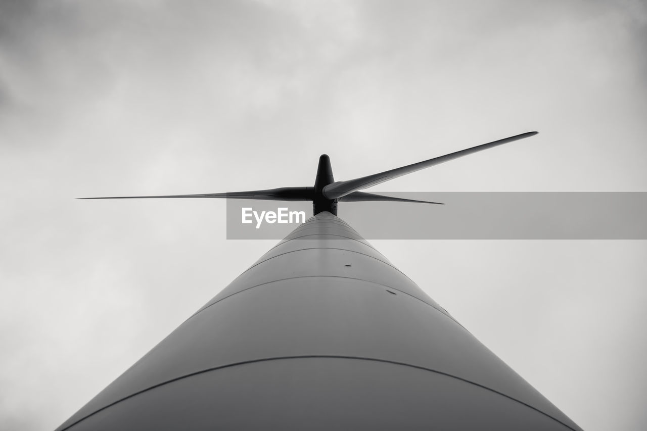 Low angle view of windmill against sky