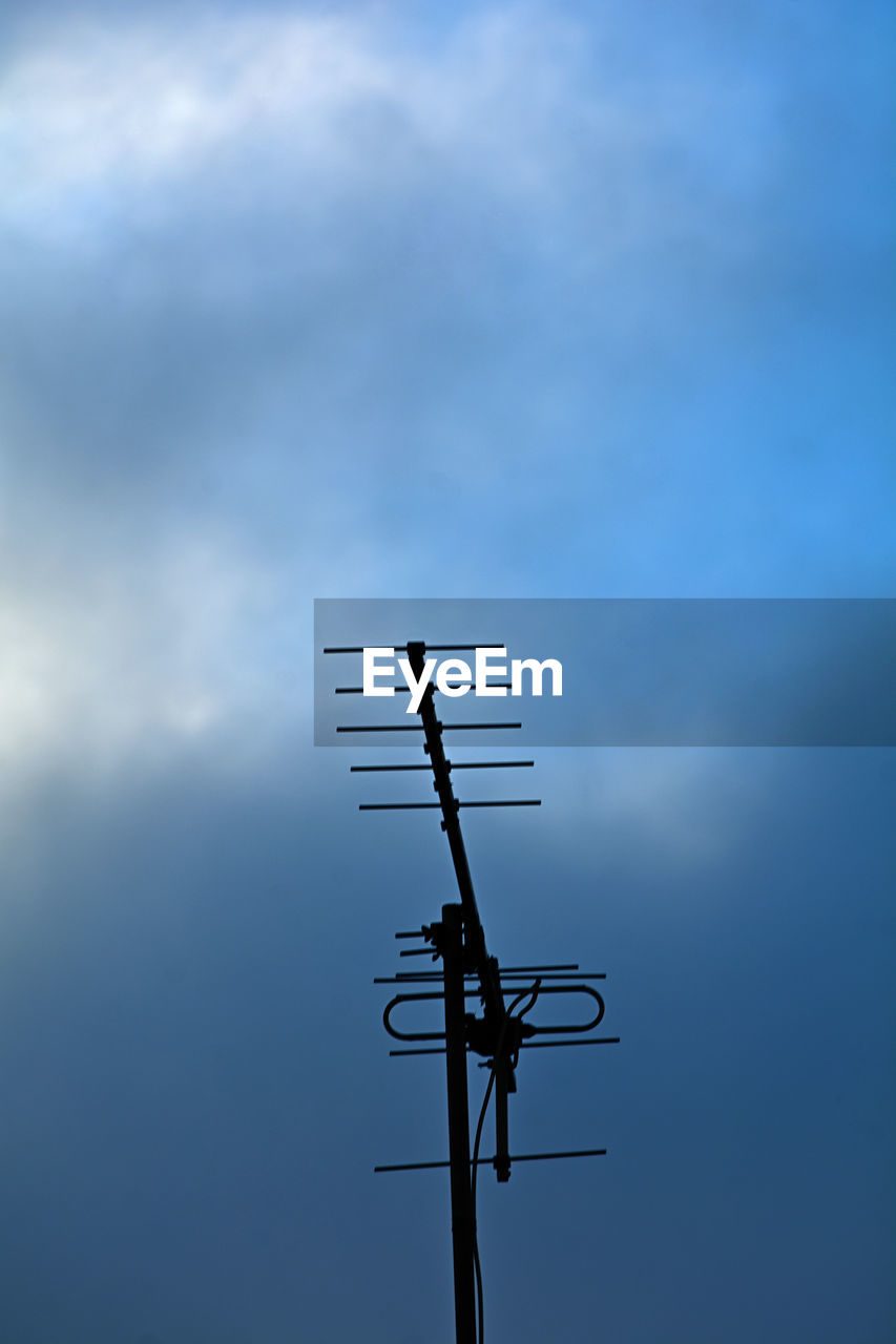 sky, blue, cloud, technology, communication, low angle view, wind, nature, no people, line, television antenna, antenna, day, electricity, outdoors, mast, silhouette, broadcasting, copy space, telecommunications equipment