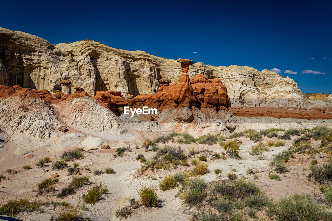 ROCK FORMATIONS IN DESERT AGAINST CLEAR SKY