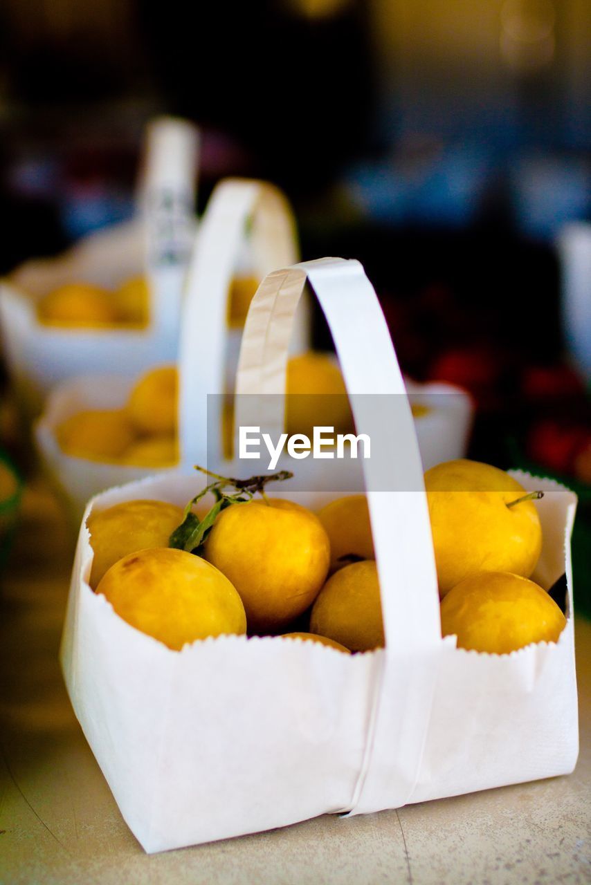 Paper basket full of apples displayed at market