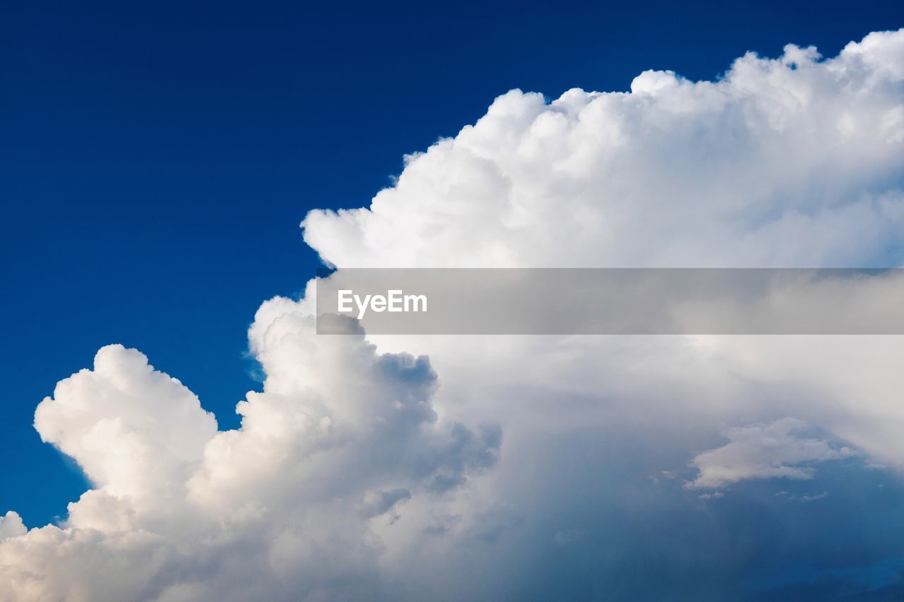 LOW ANGLE VIEW OF CLOUDS AGAINST BLUE SKY