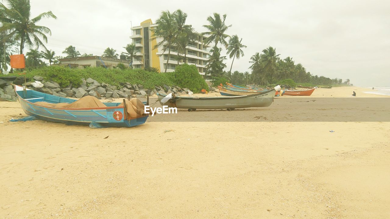 BOATS MOORED AT BEACH