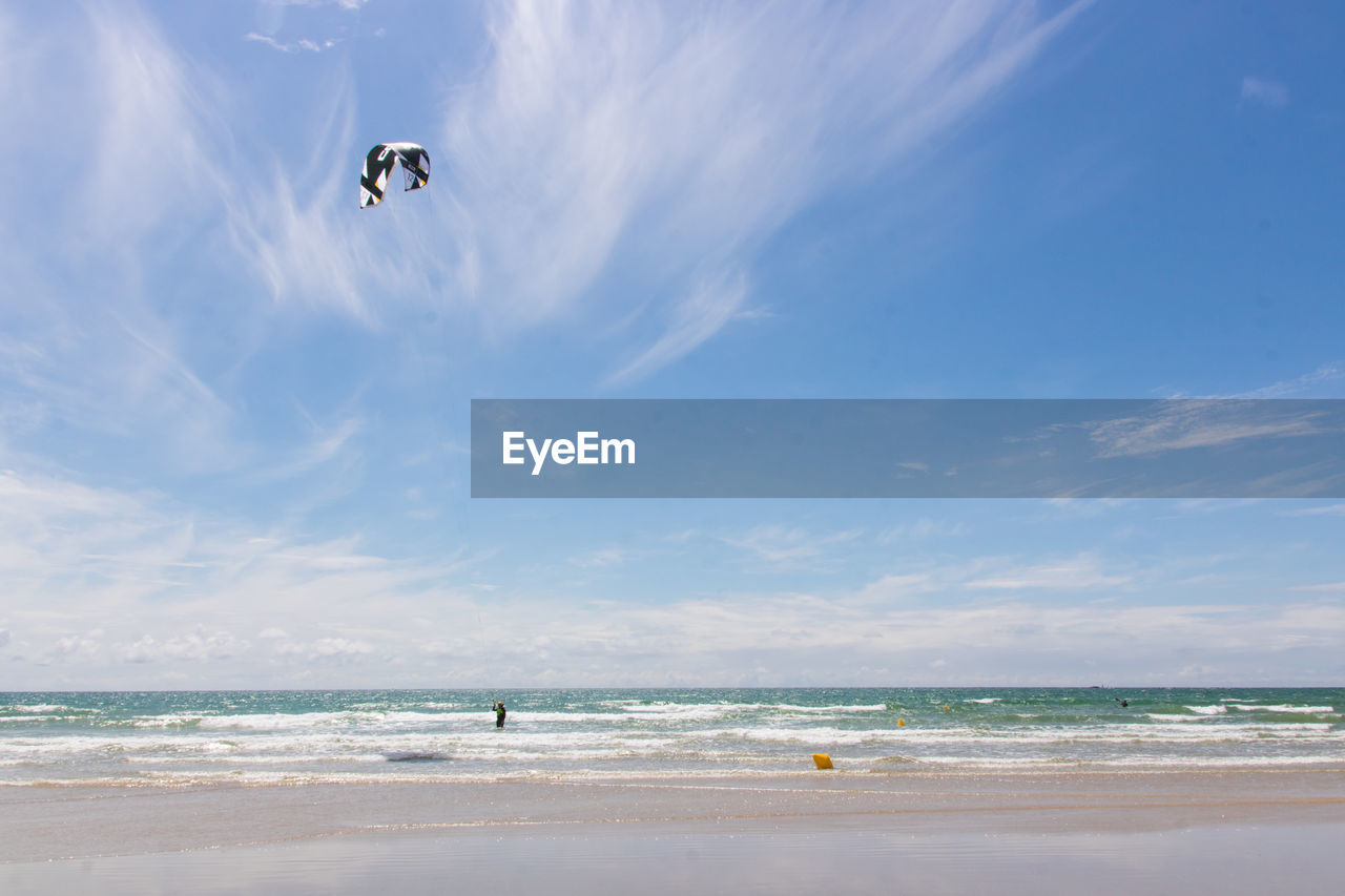 View of a beach in brittany with a kitesurf