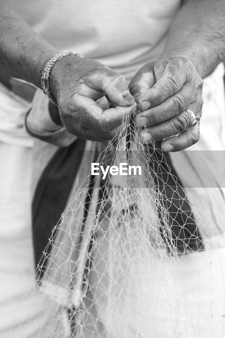 Close-up of man holding fishing net