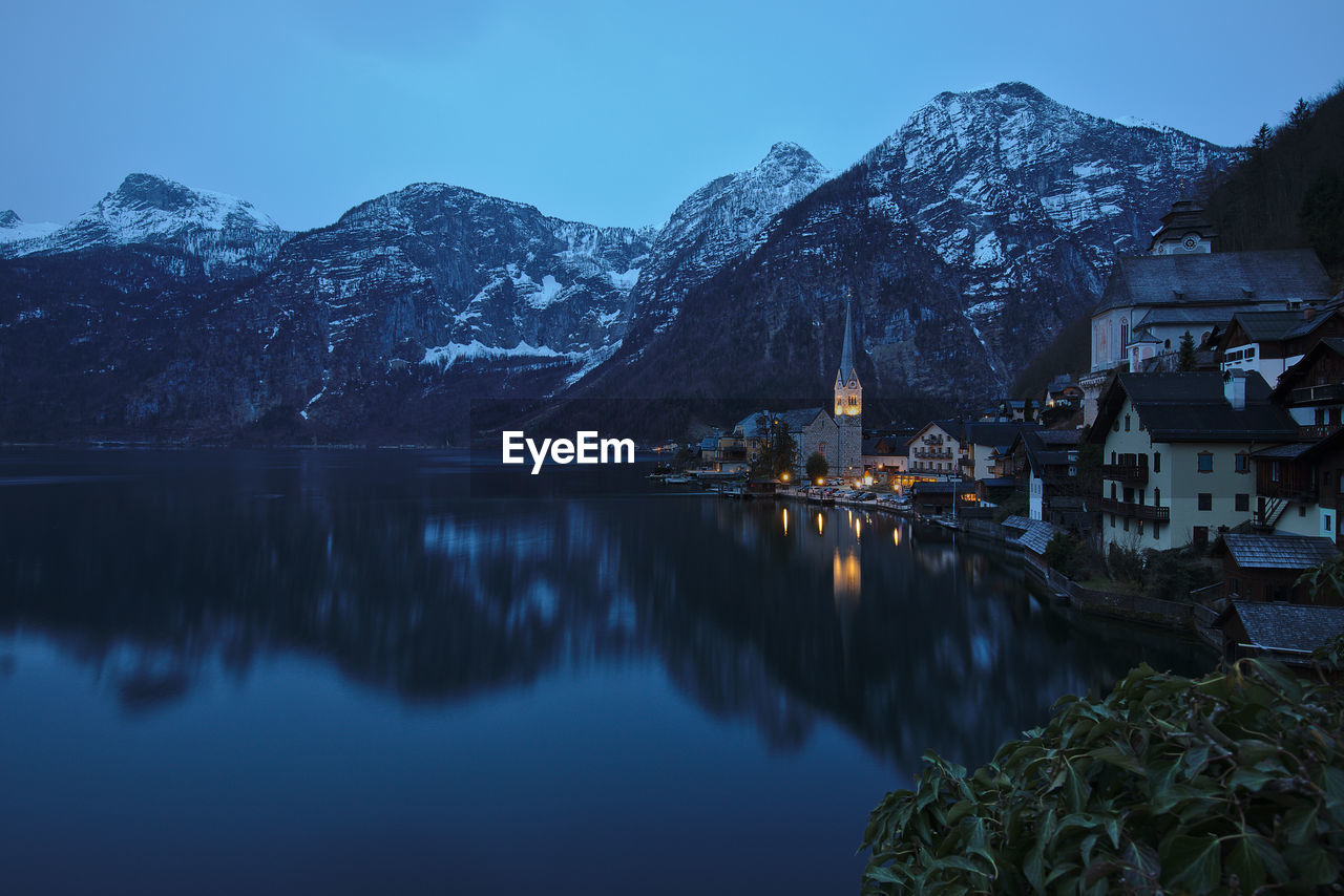 Scenic view of lake and mountains against sky during winter