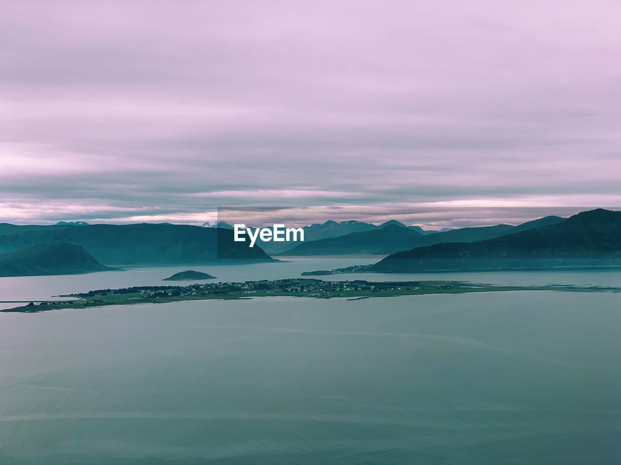 Aerial view of the norwegian coast, fjords and mountain ranges, cloudy weather, evening light 