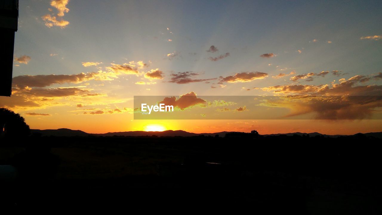 SILHOUETTE OF LANDSCAPE AT SUNSET