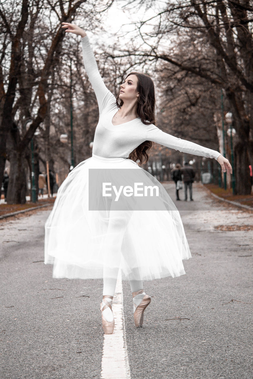 Ballerina dancing on road