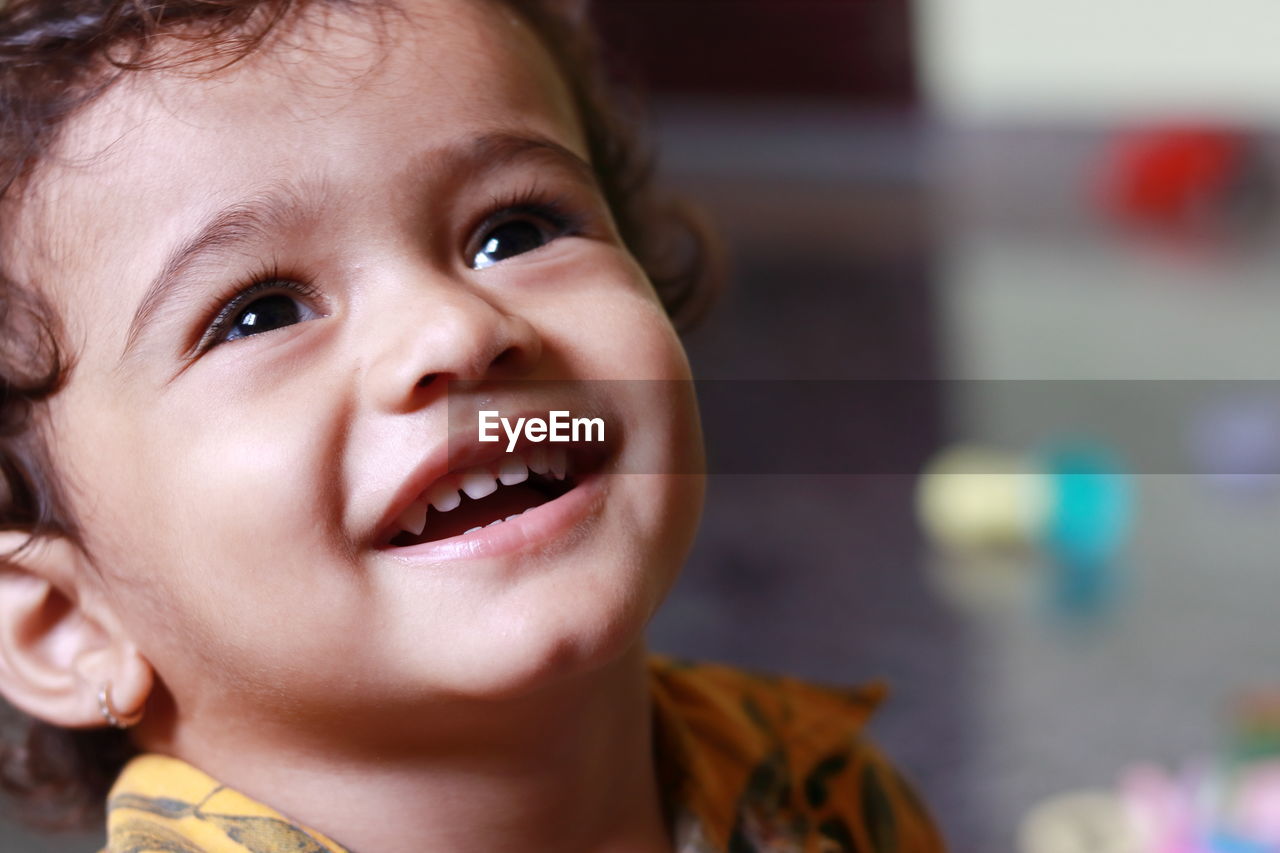 A close-up picture of a child in which the child is seen laughing