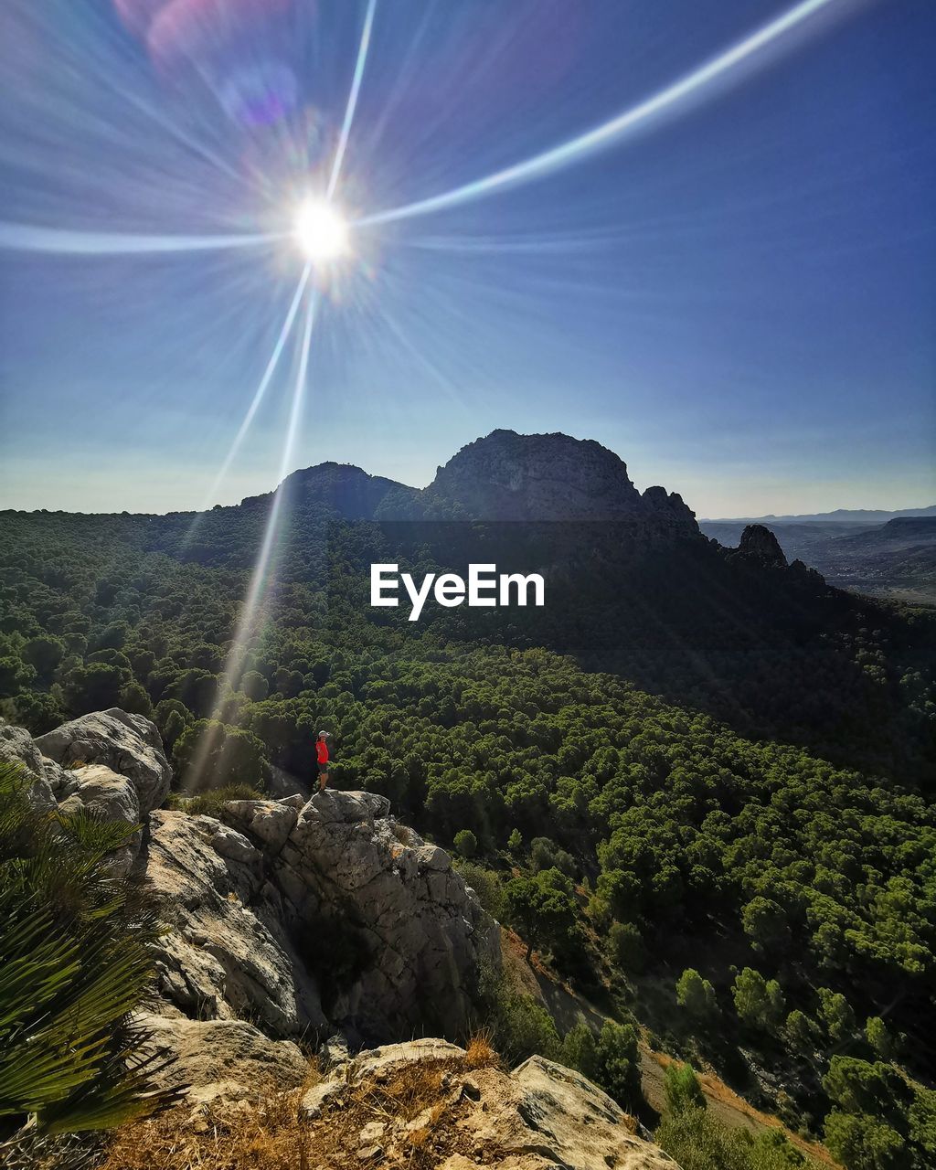 SCENIC VIEW OF MOUNTAIN AGAINST BRIGHT SUN