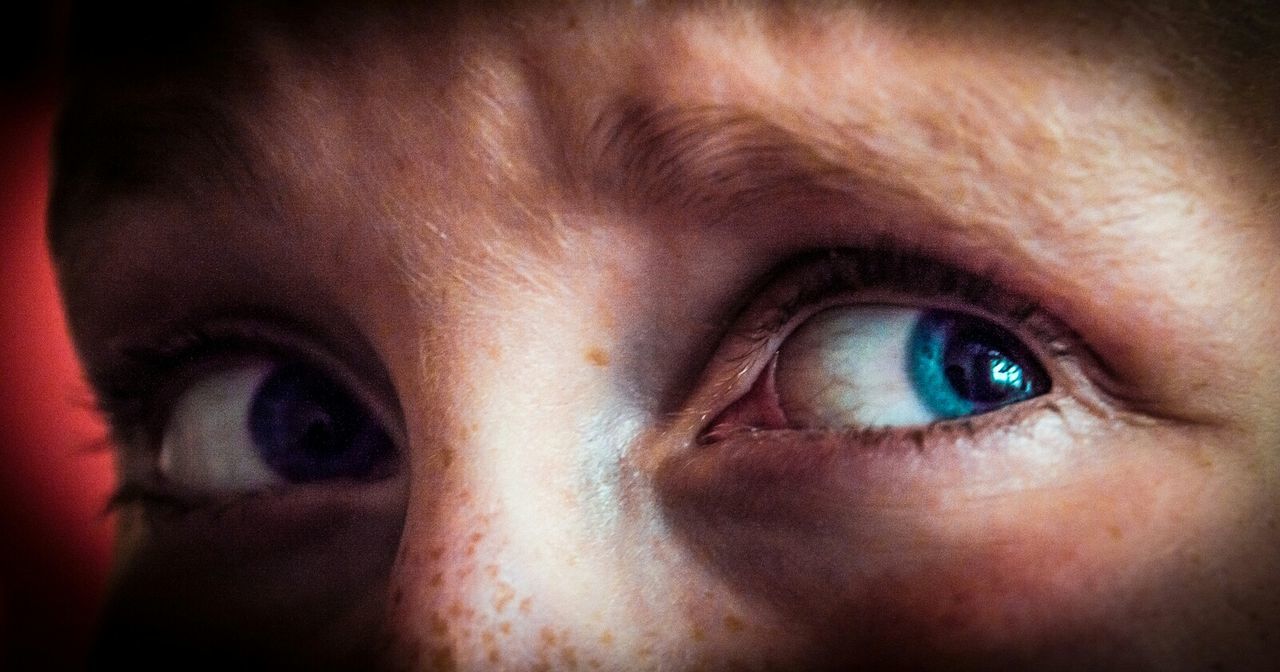 EXTREME CLOSE UP OF YOUNG WOMAN EYE