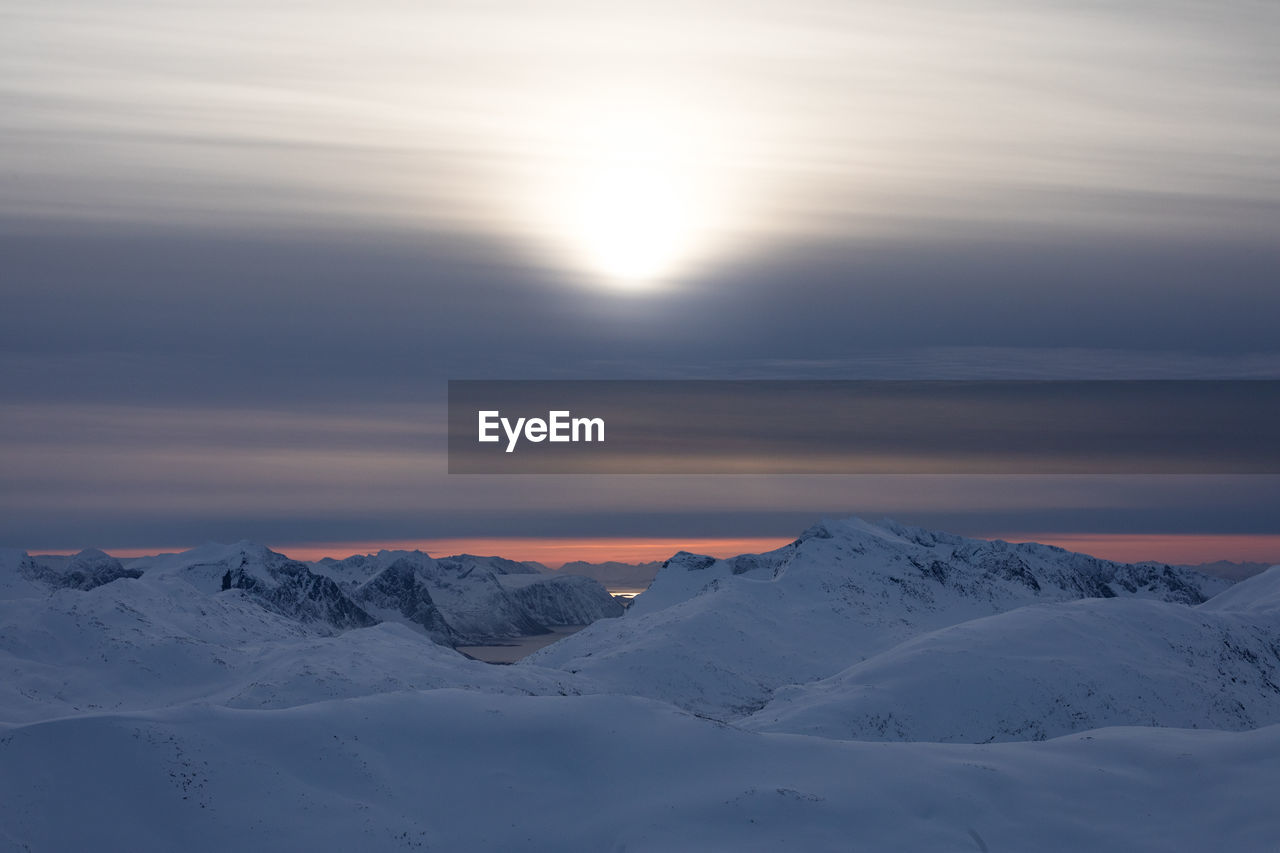 Scenic view of snowcapped mountains against sky during sunset