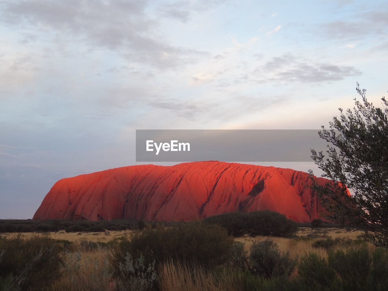 Scenic view of rock formation against sky at sunset