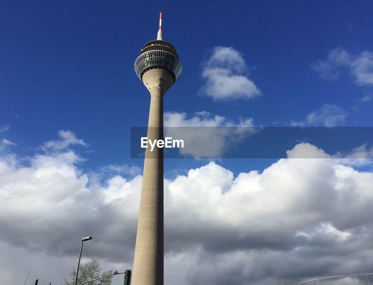 Low angle view of rheinturm tower against sky