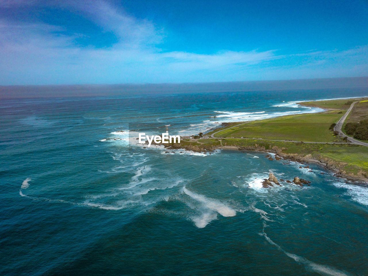 SCENIC VIEW OF BEACH AGAINST BLUE SKY