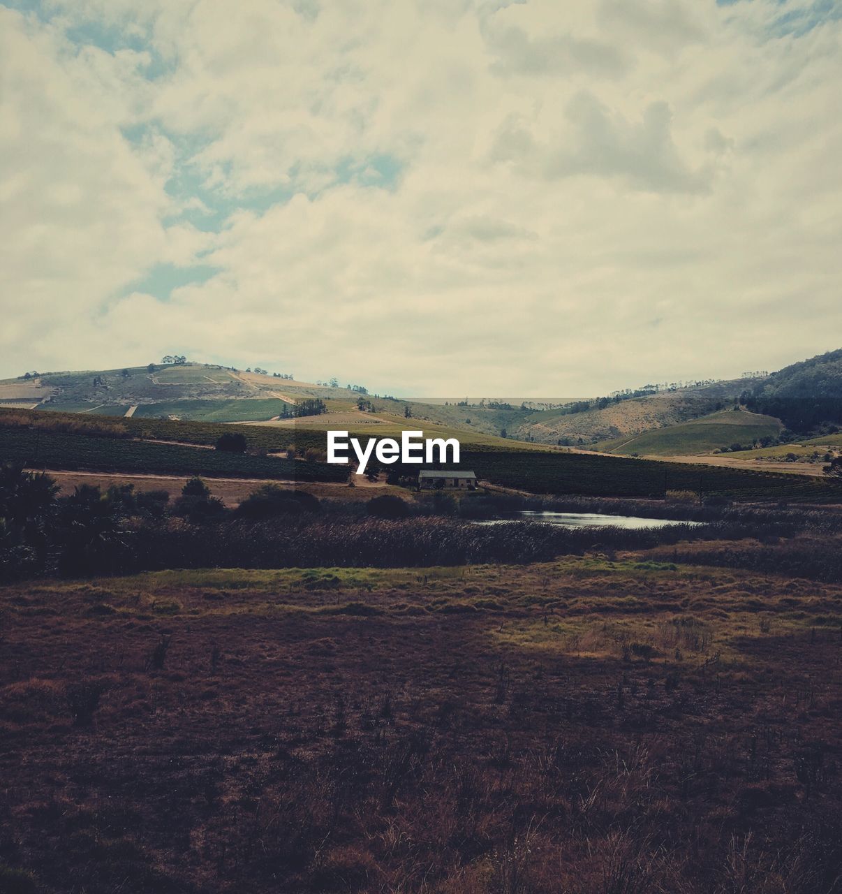 SCENIC VIEW OF MOUNTAINS AGAINST CLOUDY SKY