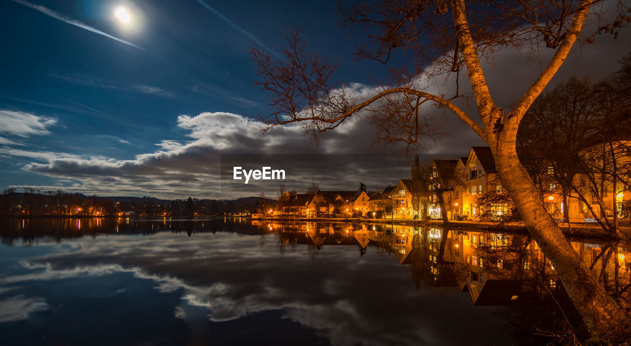 Scenic view of lake against sky at night