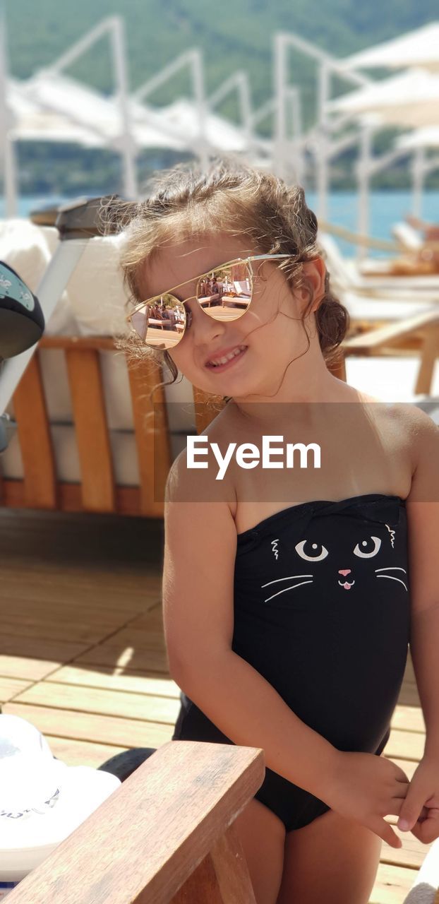 Girl wearing sunglasses and swimwear