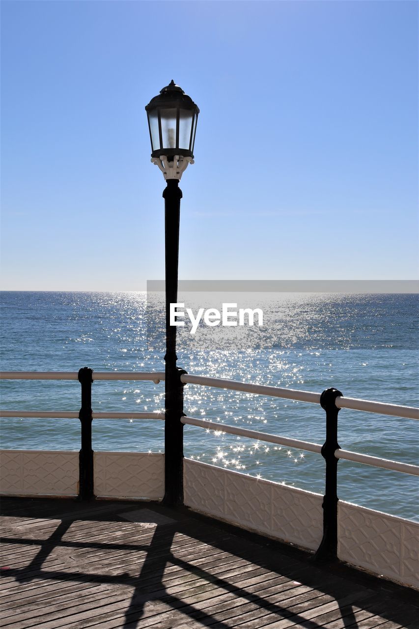 STREET LIGHT ON SEA AGAINST CLEAR SKY