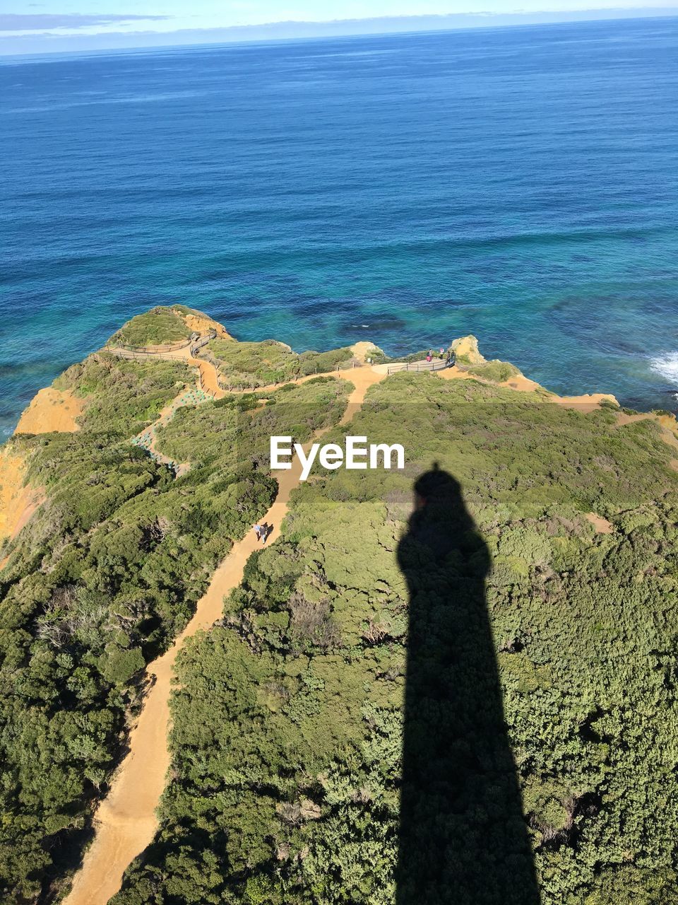 HIGH ANGLE VIEW OF SHADOW ON SEA SHORE