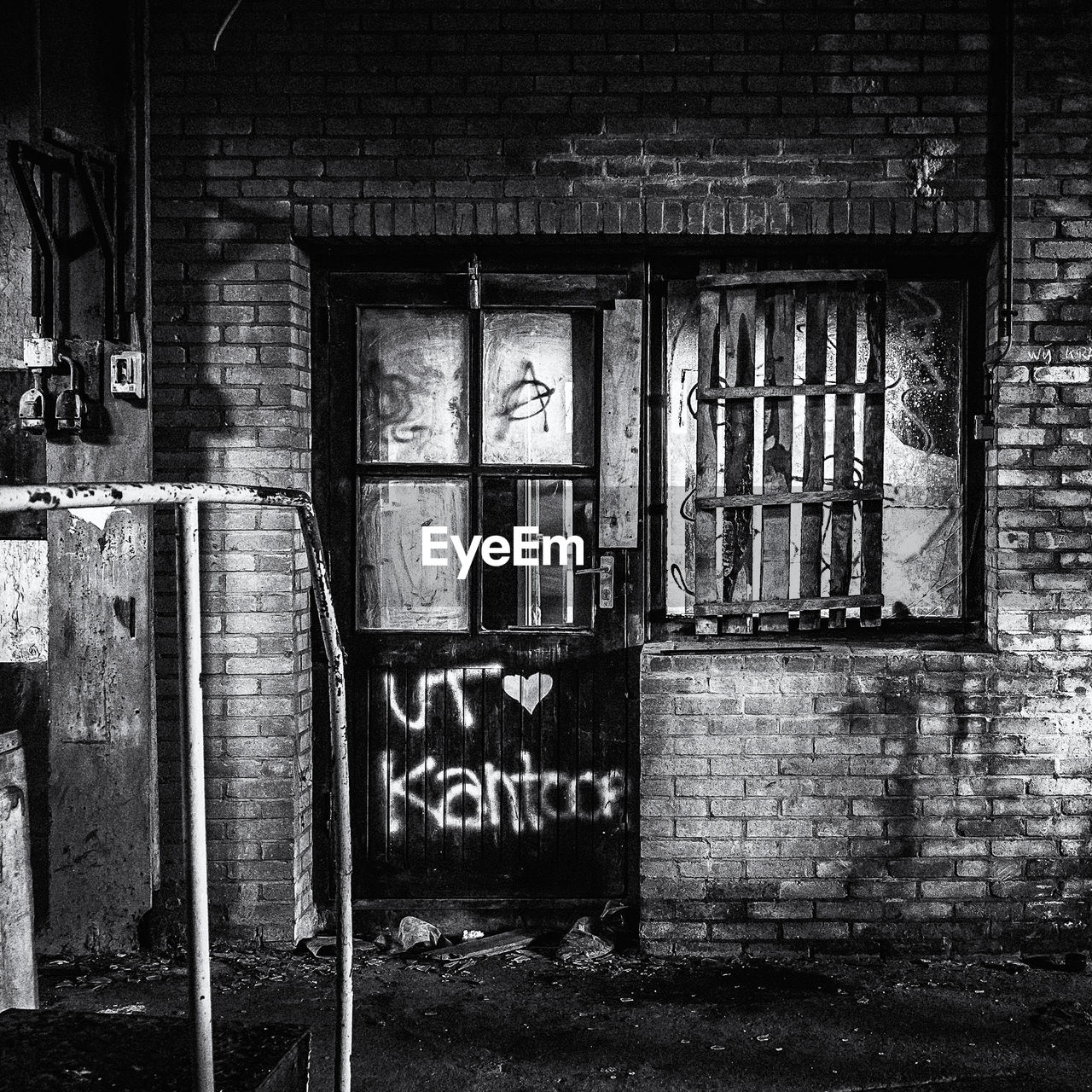 GRAFFITI ON WINDOW OF ABANDONED BUILDING