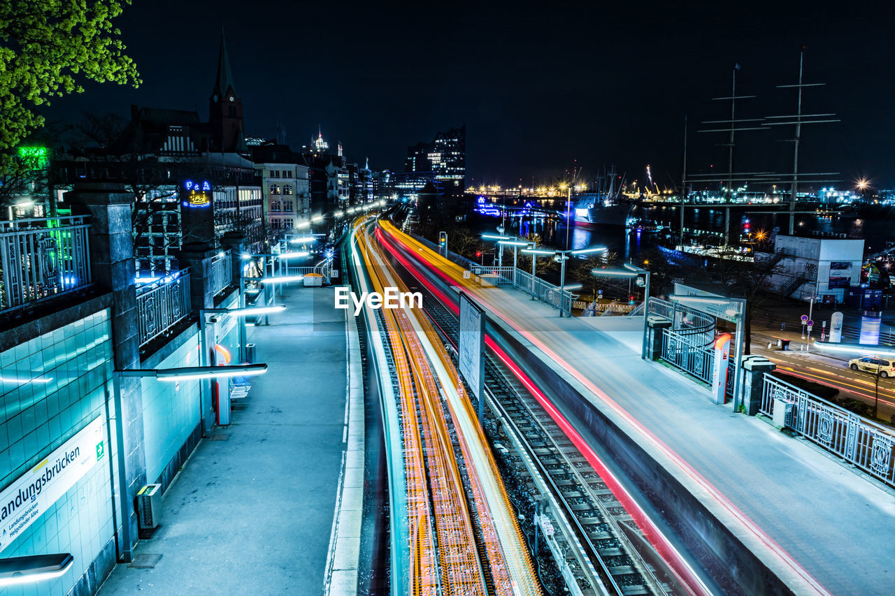 HIGH ANGLE VIEW OF LIGHT TRAILS ON CITY STREET AT NIGHT