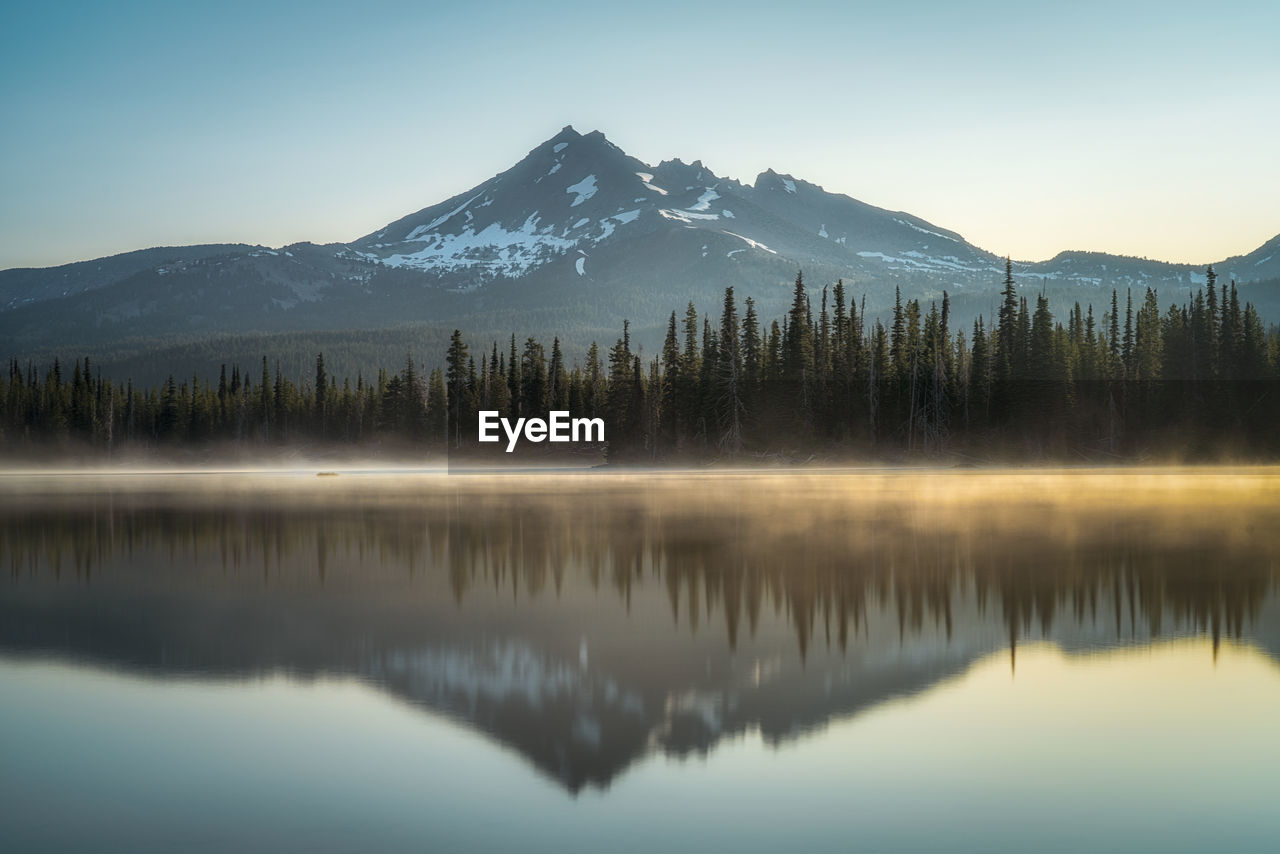 Scenic view of lake and mountains against sky