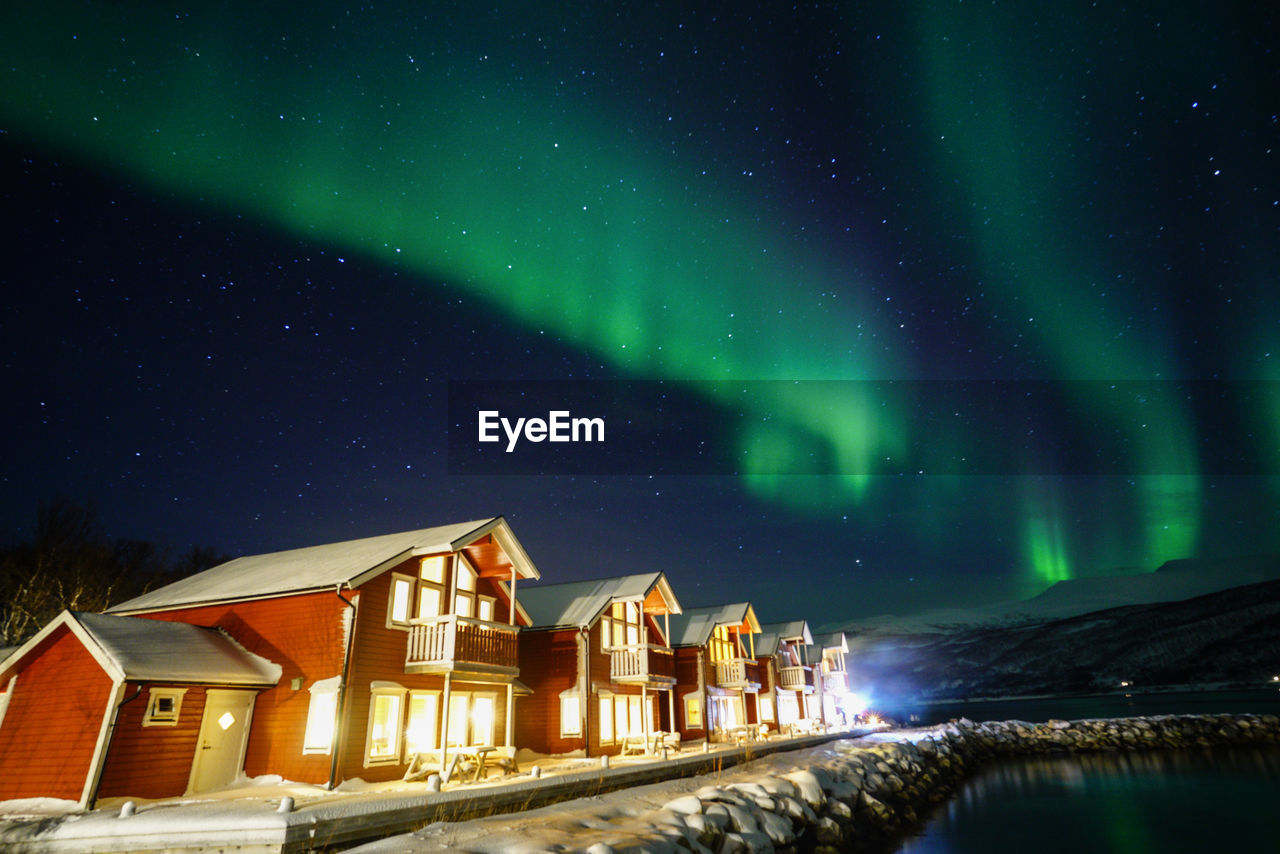 Scenic view of illuminated building against sky at night