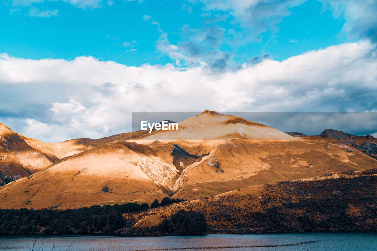 Scenic view of mountain against cloudy sky