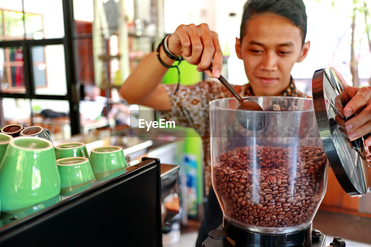 Barista preparing coffee at cafe