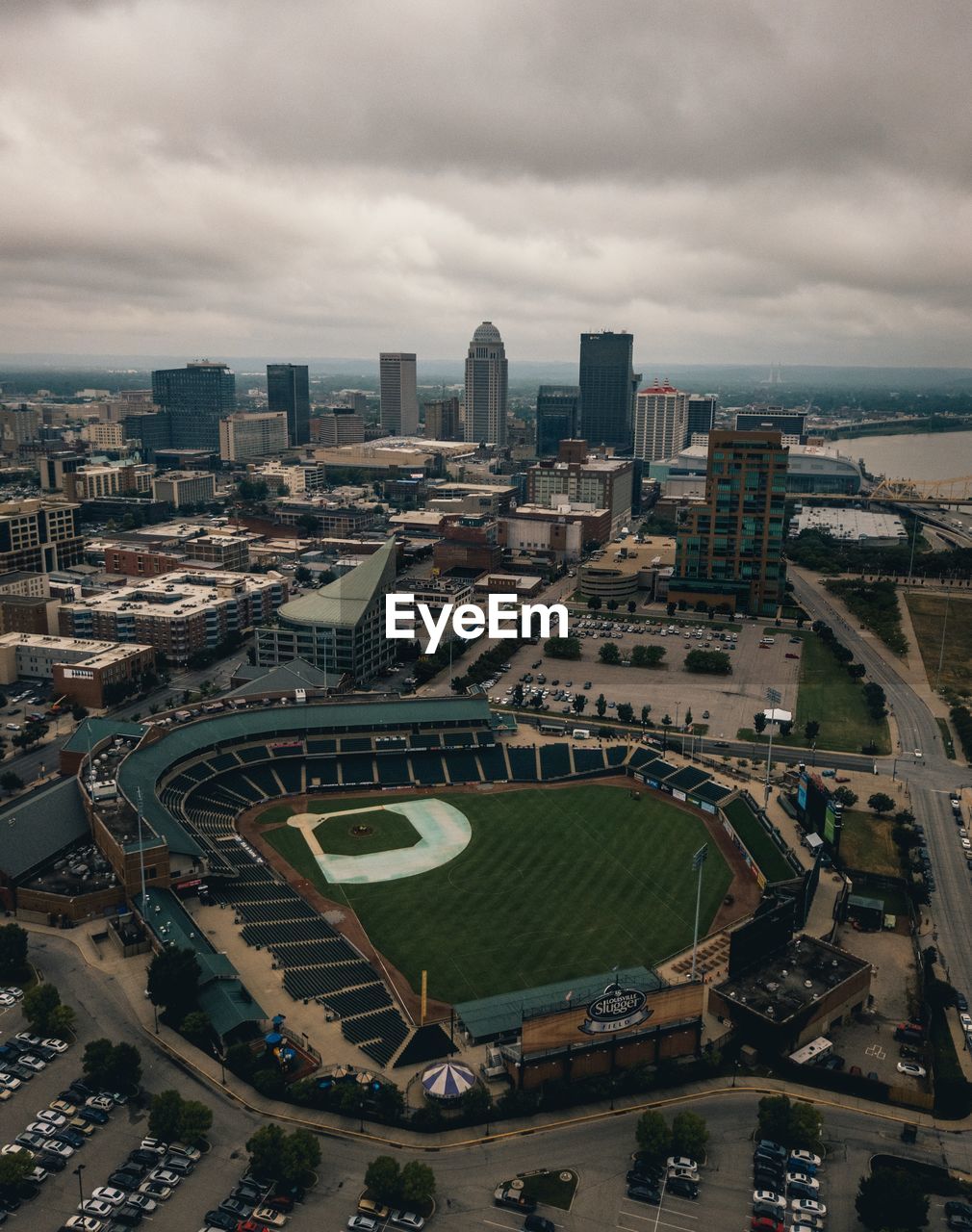 High angle view of city buildings against cloudy sky